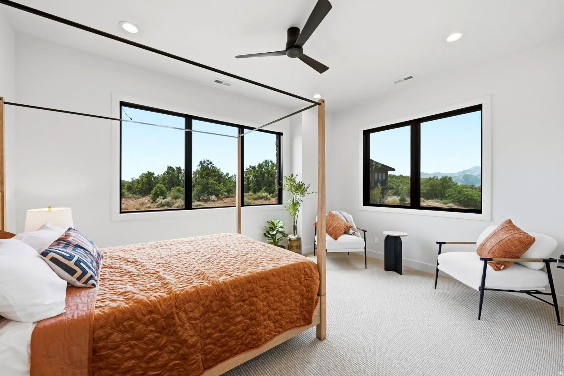White walls complement large windows with black frames