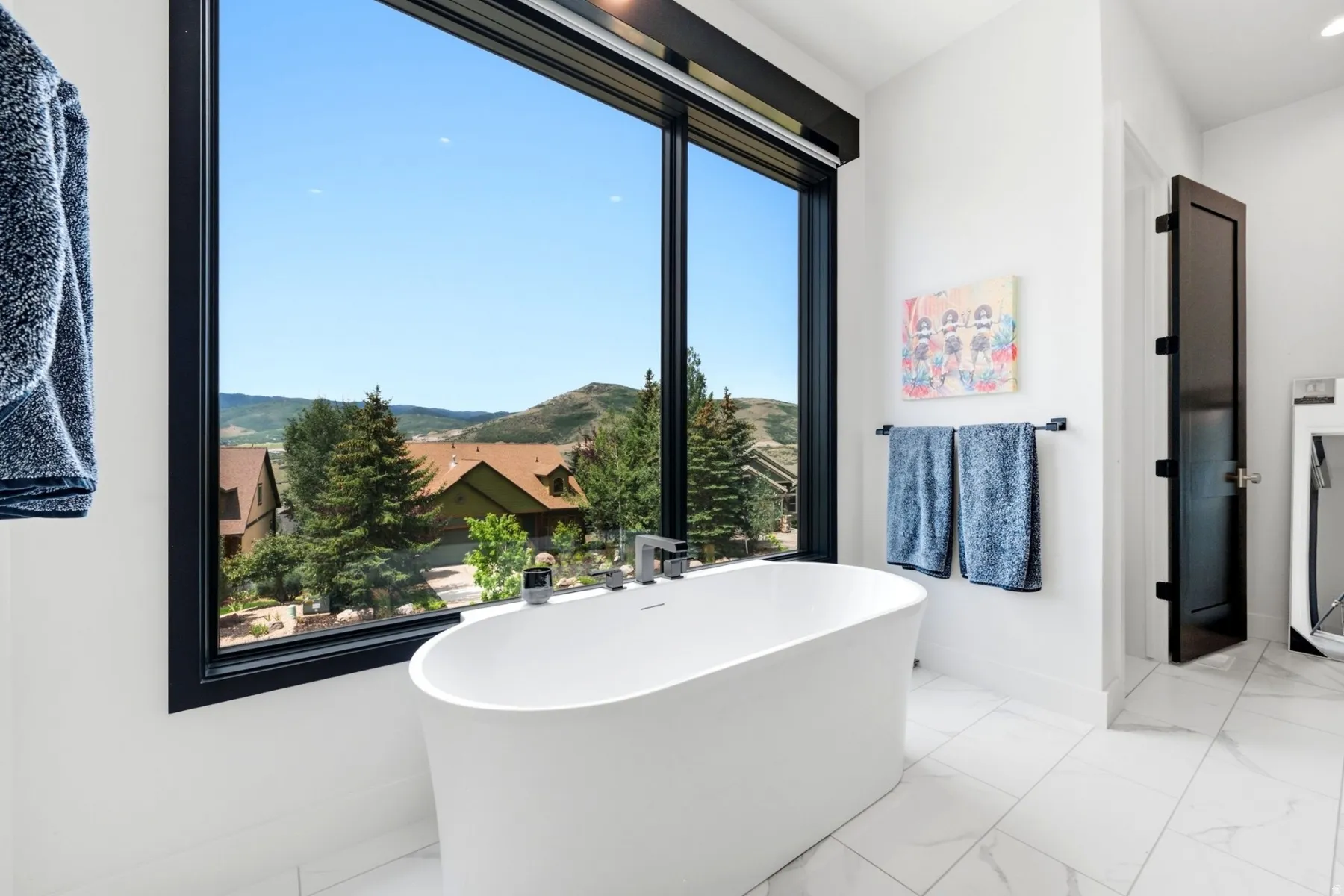Freestanding soaking tub with floor-to-ceiling window