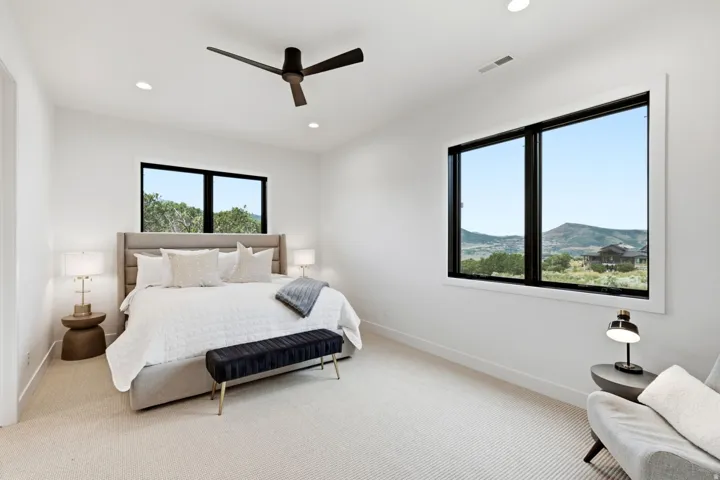 Recessed ceiling lights, ceiling fan, large windows, and wall-to-wall carpeting
