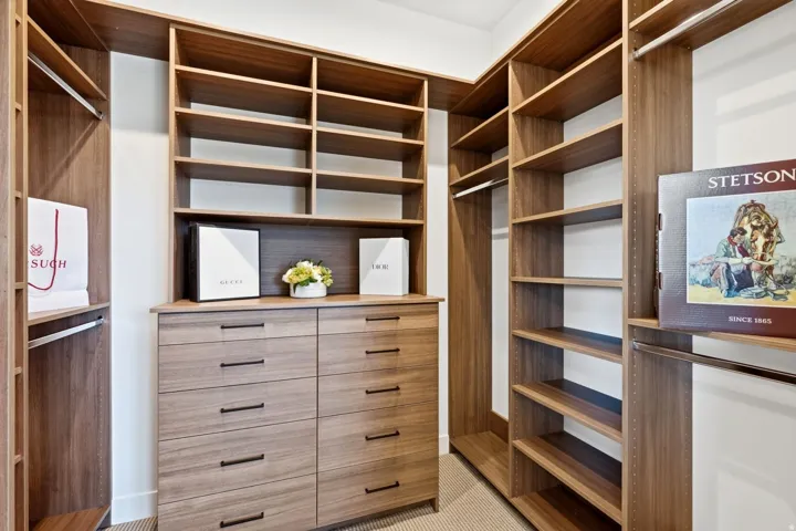 Custom closet system featuring wood-finish shelving and built-in drawers