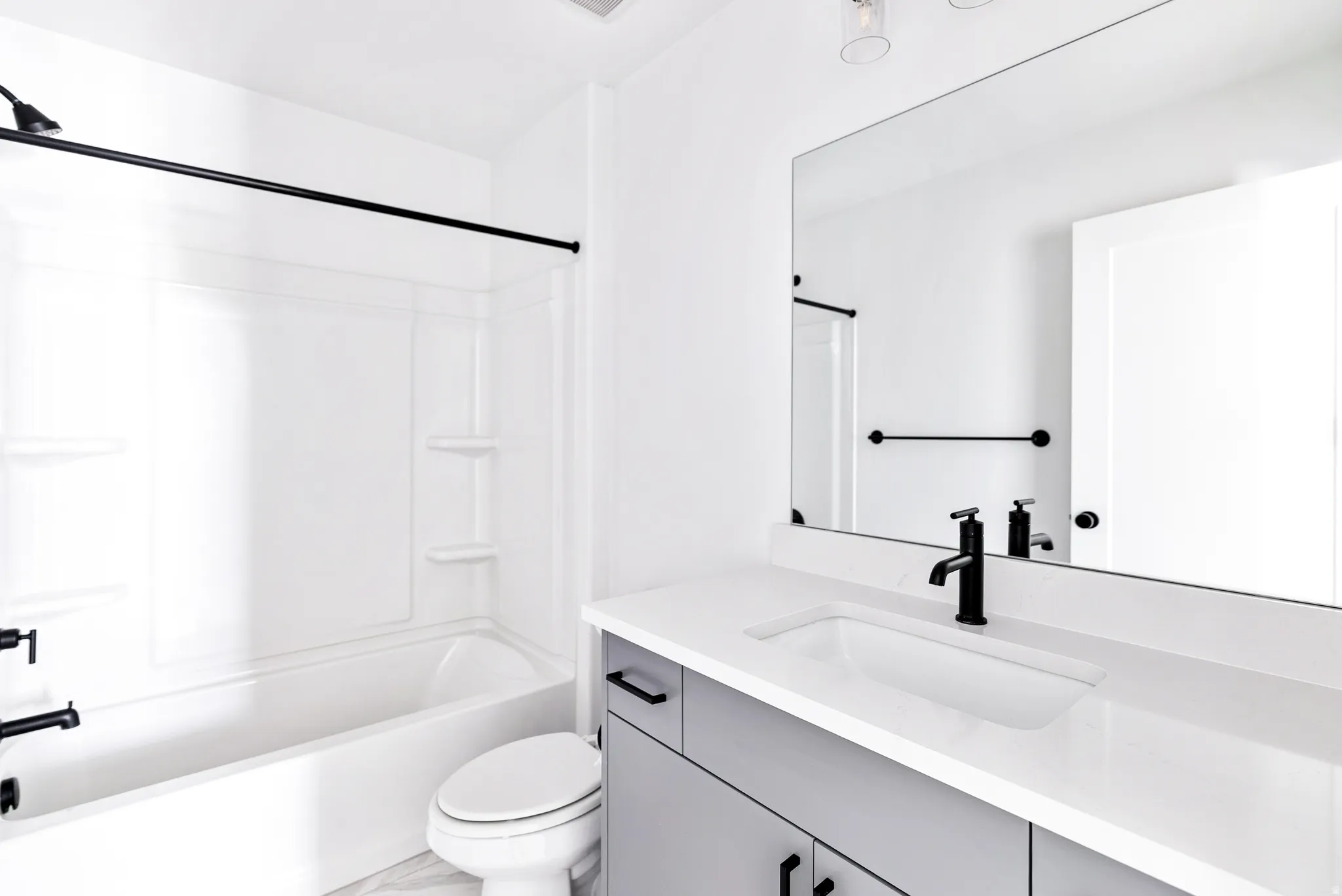 White bathtub with black-finish fixtures