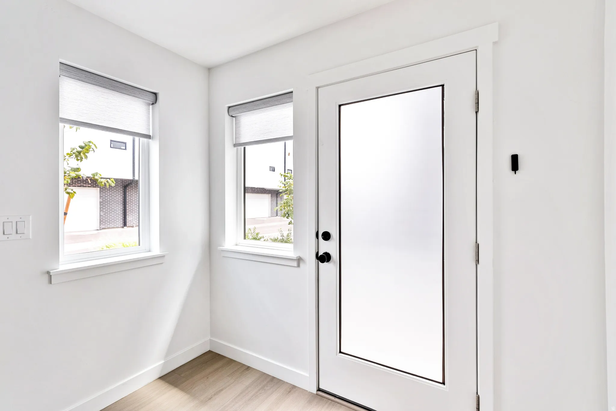 Light wood-finish flooring complements the crisp white walls
