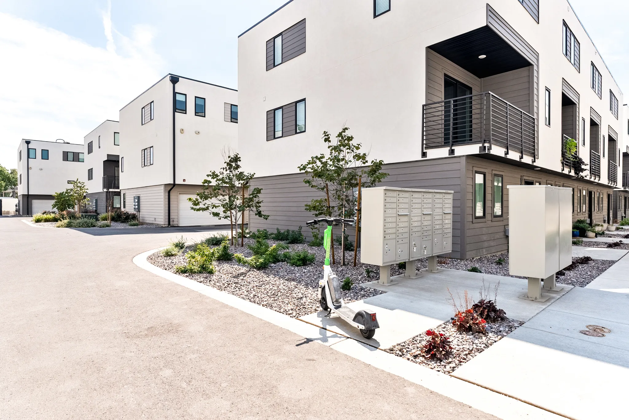 Modern multi-story exterior with white facade and dark trim