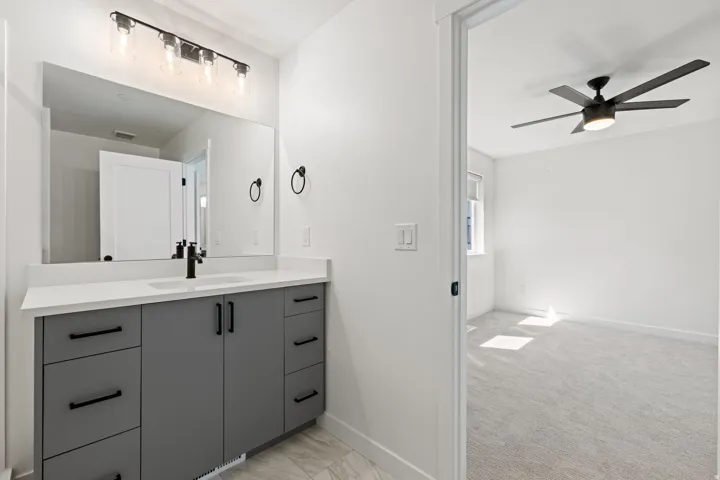 Modern bathroom vanity with a white countertop and rectangular undermount sink
