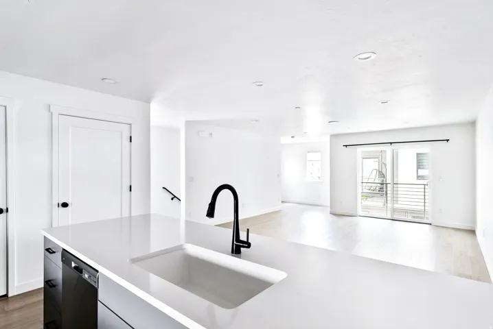 Kitchen island with an undermount sink, matte black pull-down faucet, and integrated dishwasher