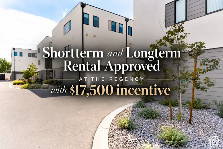 Contemporary multi-story exterior featuring smooth stucco facade, horizontal siding accents, dark-framed windows, and asphalt driveway with xeriscaped landscaping