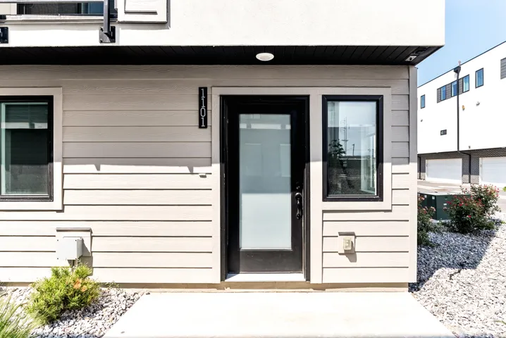Contemporary exterior with light-toned horizontal siding and dark trim