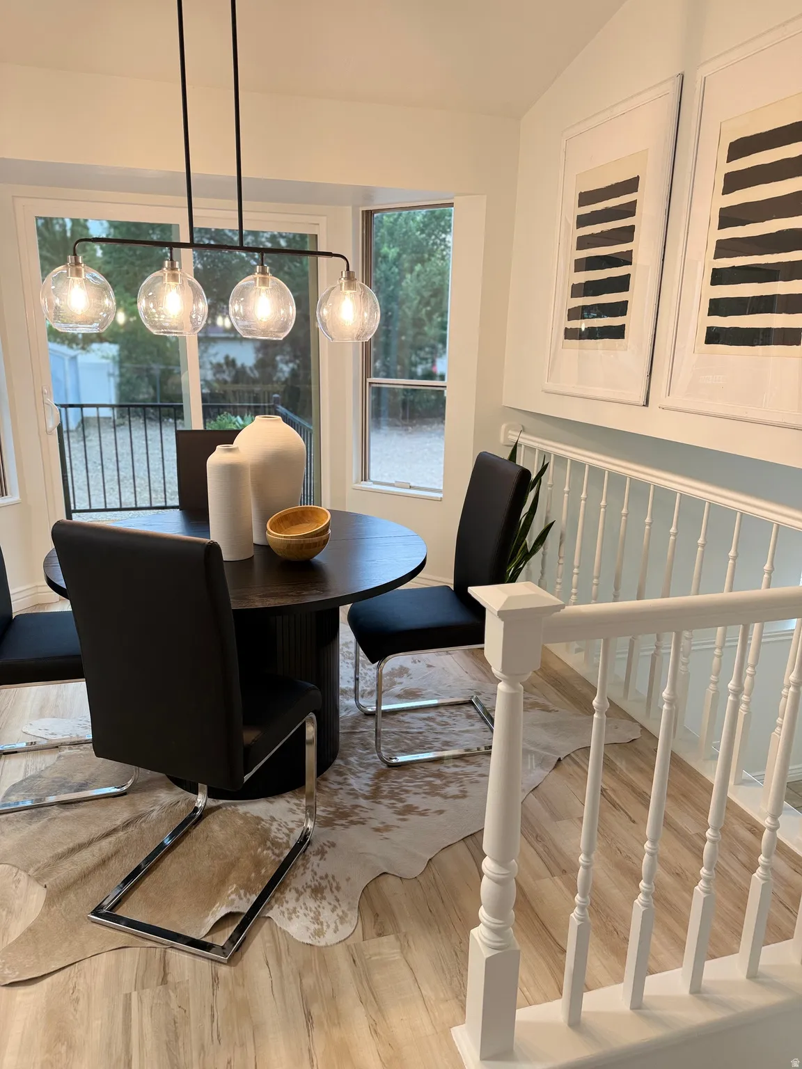 Light wood-finish flooring with white railing