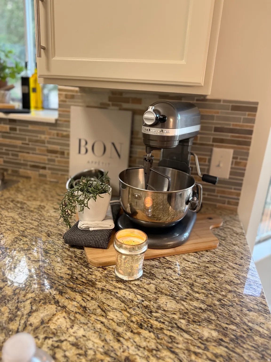 Granite countertop with a multi-toned tile backsplash