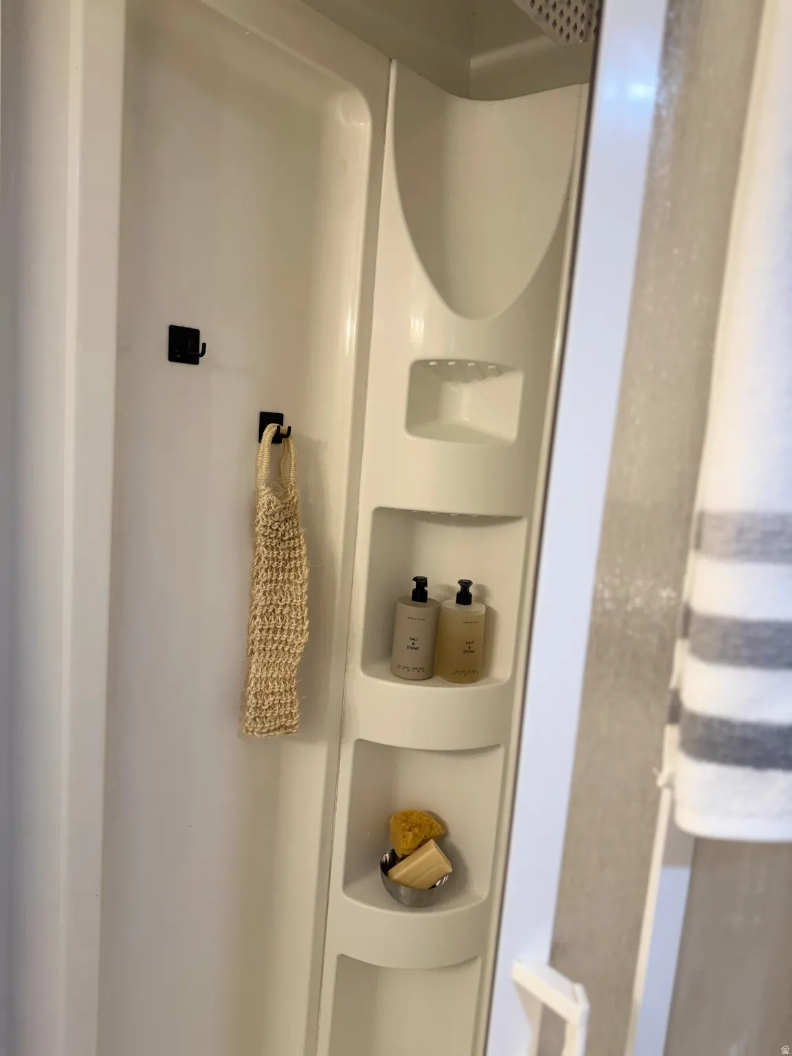 Bath for the 4th and 5th bedrooms on the mid and lower levels.White shaker-style vanity with a single basin sink, brushed nickel faucet, and a large framed mirror