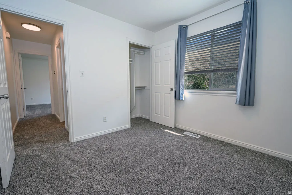 Neutral wall paint, gray carpeting, and white trim throughout
