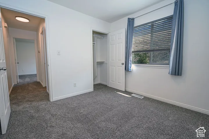 Neutral wall paint, gray carpeting, and white trim throughout