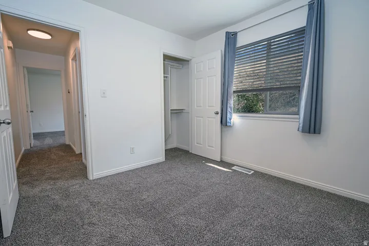 Neutral wall paint, gray carpeting, and white trim throughout