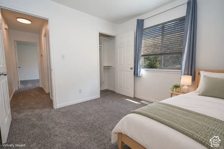 Neutral-toned carpeting, multi-panel interior doors, and a built-in closet with integrated shelving