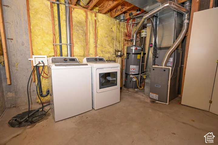 Laundry area with concrete flooring, exposed ceiling joists, and insulated wall framing