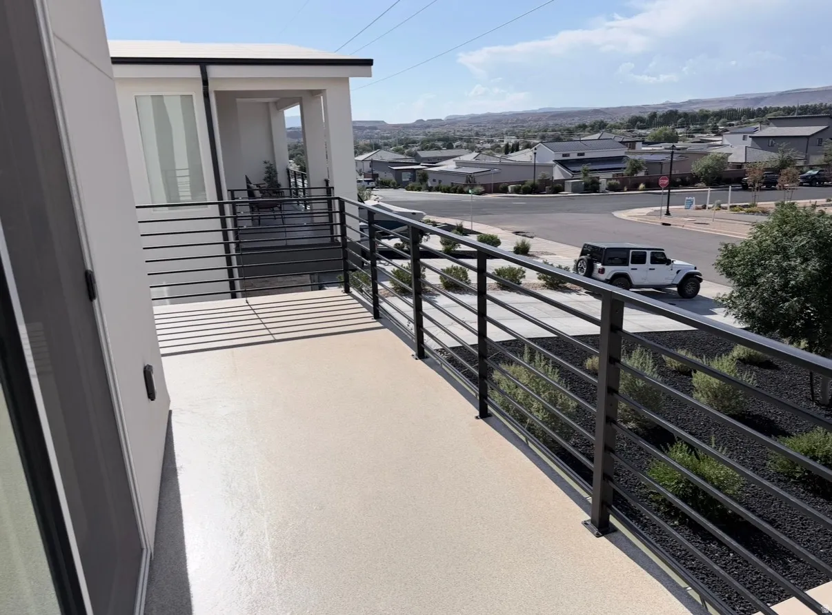 Balcony with a neutral-toned surface and horizontal metal railings