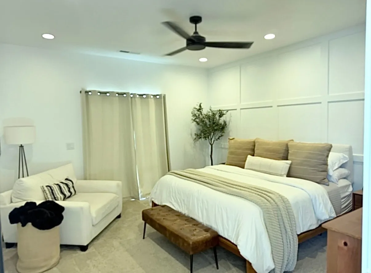Recessed lighting, ceiling fan, accent wall with paneling, and light-toned flooring