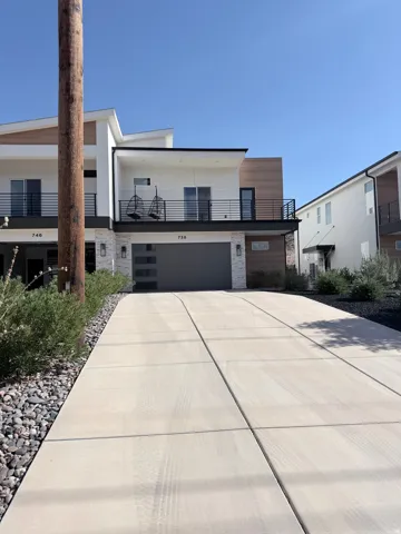 Modern architectural facade with horizontal wood-finish siding, white stucco, and stone accents