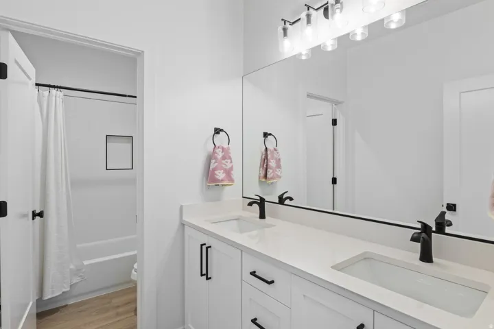 Dual vanity with undermount sinks and matte black fixtures