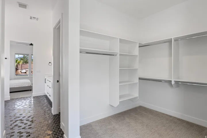 Walk-in closet with built-in shelving and hanging rods