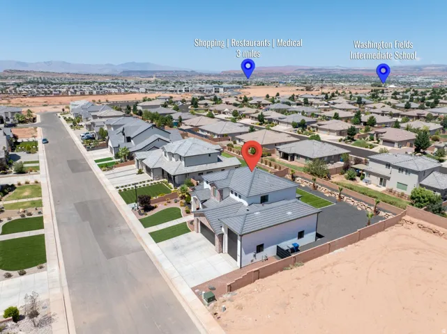 New construction residence with an attached garage, featuring a tiled roof and stucco exterior, situated in a developed neighborhood