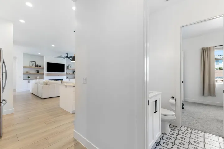 Light wood-finish flooring, recessed lighting, and a modern ceiling fan