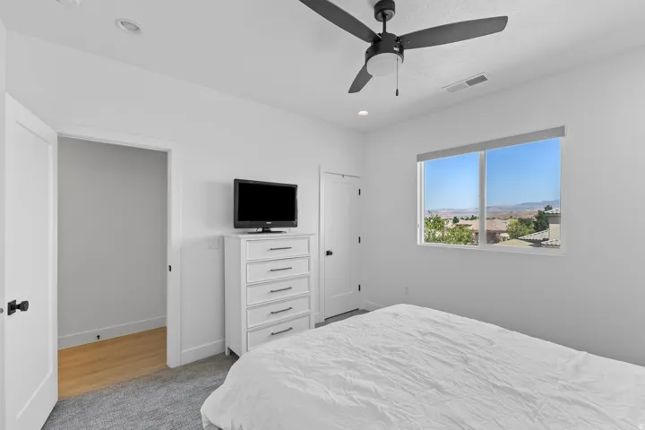 Recessed lighting, ceiling fan with integrated light, large window with expansive outdoor scenery, white trim, and light-toned walls