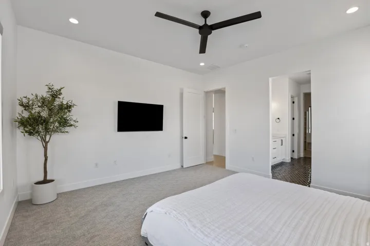 Recessed lighting, ceiling fan, carpeting, and white interior doors
