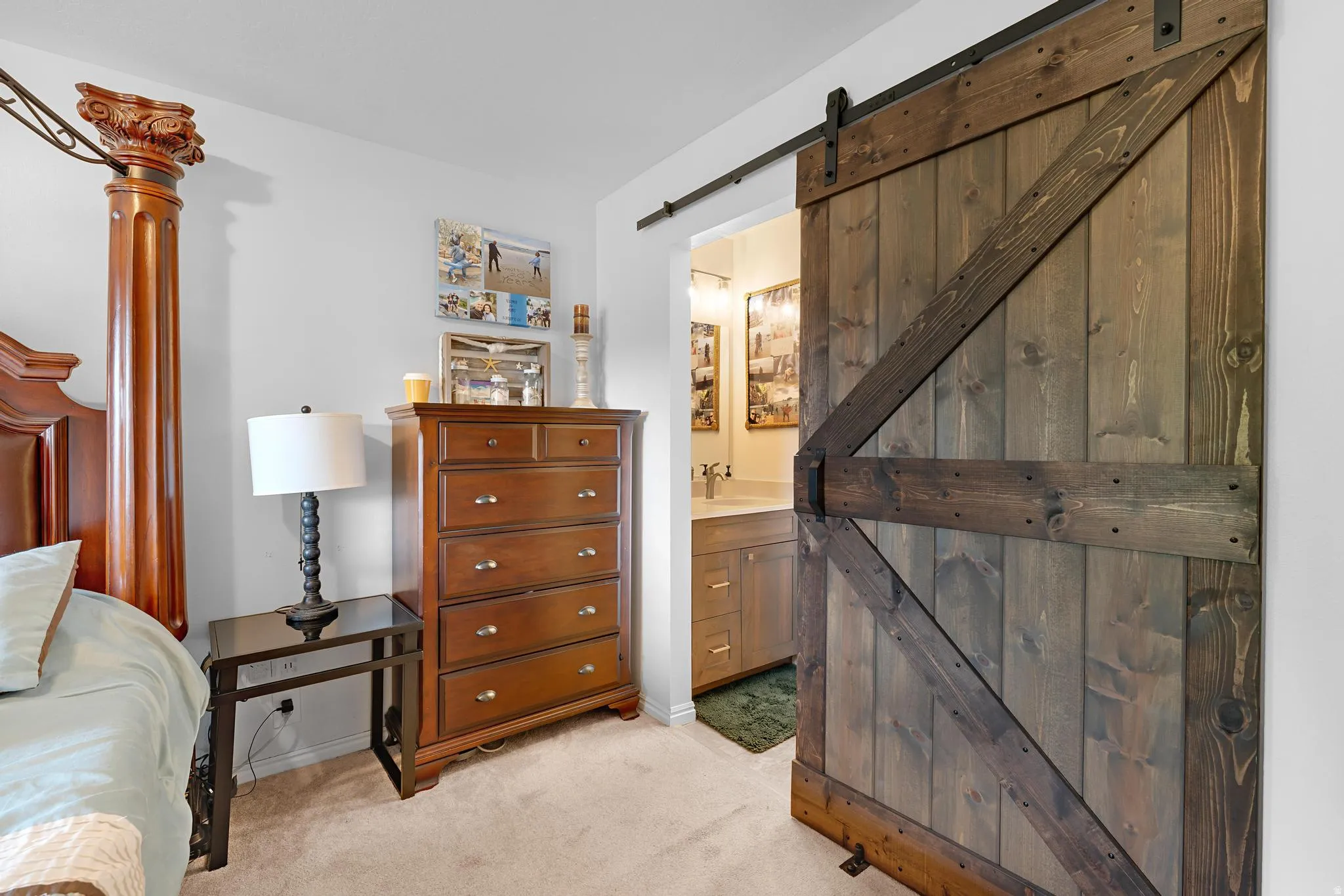 Barn door entry to bathroom with vanity and integrated sink