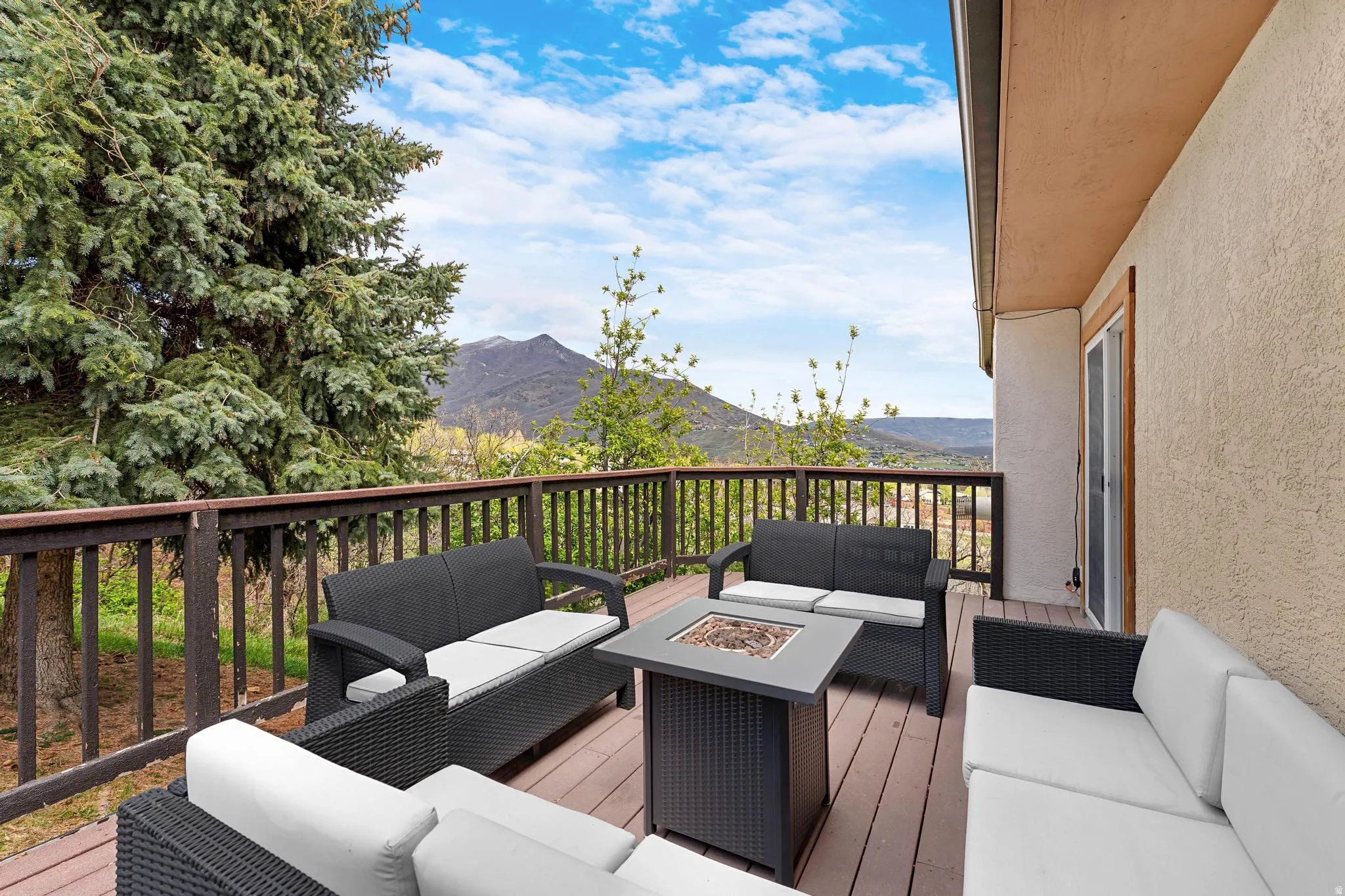 Expansive outdoor deck with wood-finish flooring and a wood railing