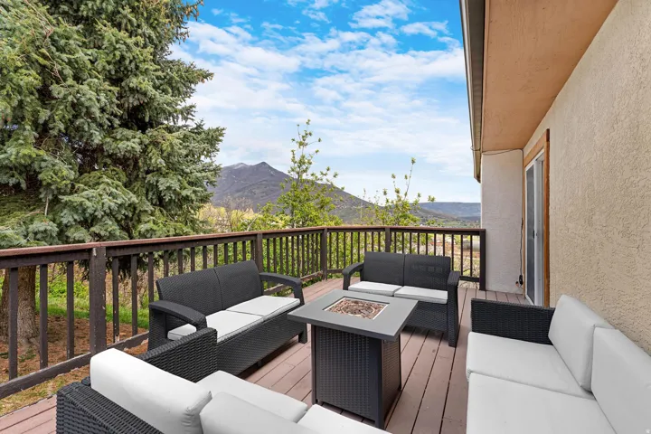 Expansive outdoor deck with wood-finish flooring and a wood railing