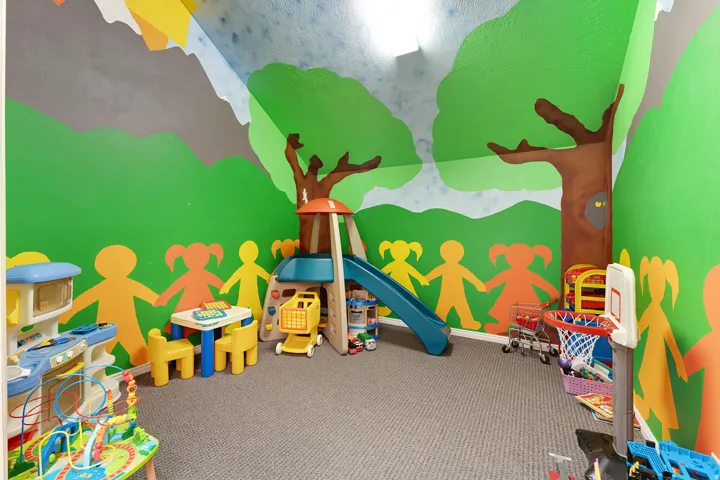 Room featuring carpeted flooring and custom wall murals