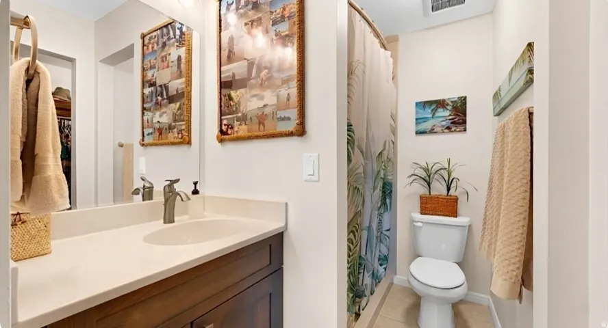 Bathroom featuring a vanity with dark wood-finish cabinetry, a white countertop, and an undermount sink
