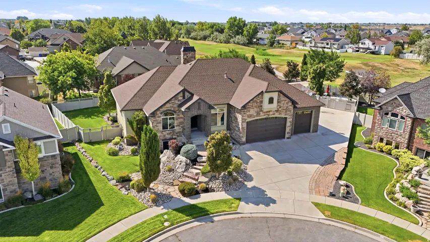 Stone and stucco exterior with an attached three-car garage