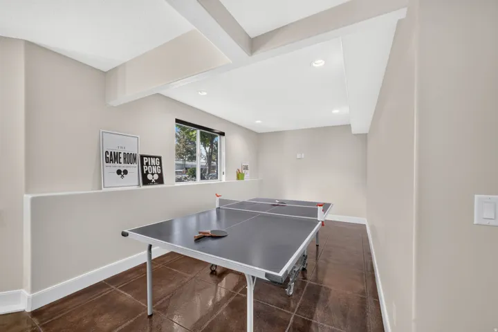 Recessed lighting, wood-finish flooring, and a large window