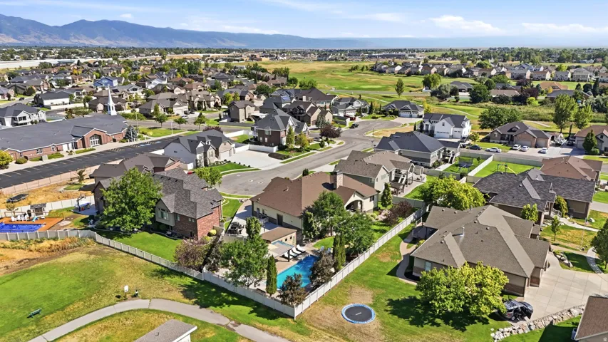 Expansive residential community featuring a variety of architectural styles, mature landscaping, and mountain backdrops