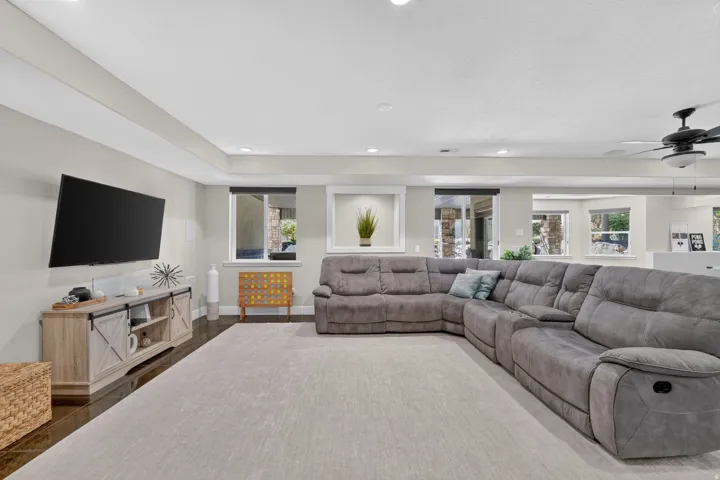 Recessed lighting, ceiling fan, and wood-finish flooring