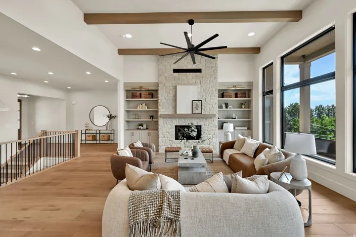Vaulted ceiling with exposed wood beams and a contemporary ceiling fan