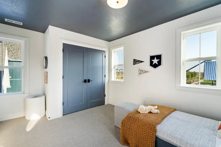 Carpeted flooring, white walls, and a dark-painted ceiling