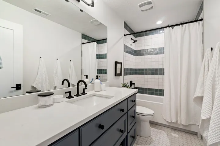 Vanity with integrated sink, matte black faucet, and white countertop