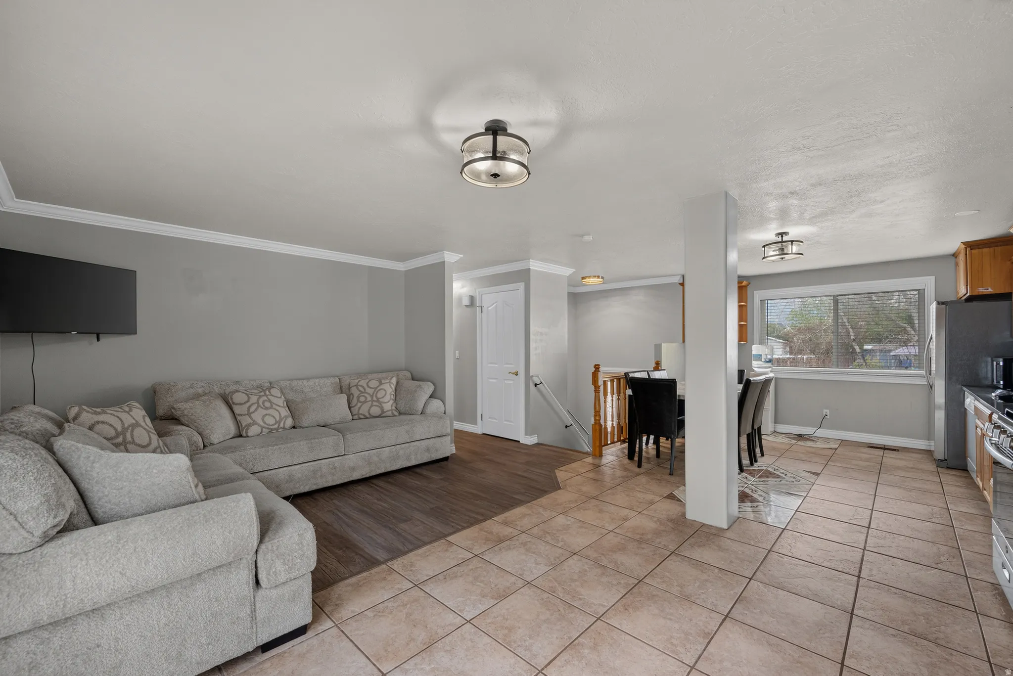 Recessed lighting, crown molding, wood-finish flooring, tiled flooring, and a large kitchen window
