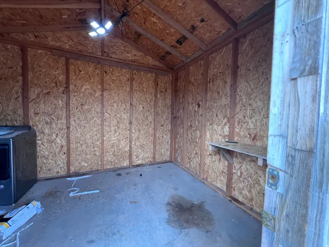 Concrete flooring and exposed timber framing with an attached workbench