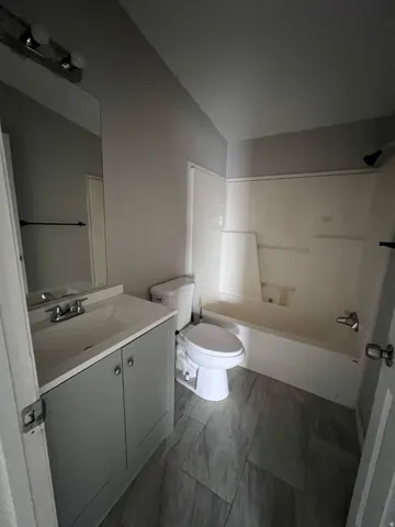 Vanity with integrated sink, chrome faucet, and cabinet storage