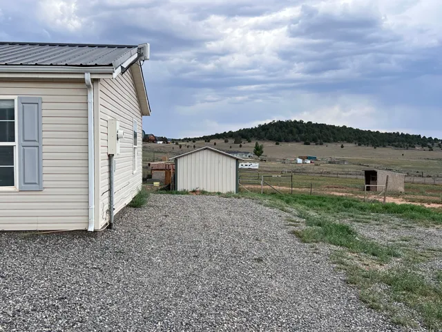 Light-colored horizontal siding with a dark metal roof