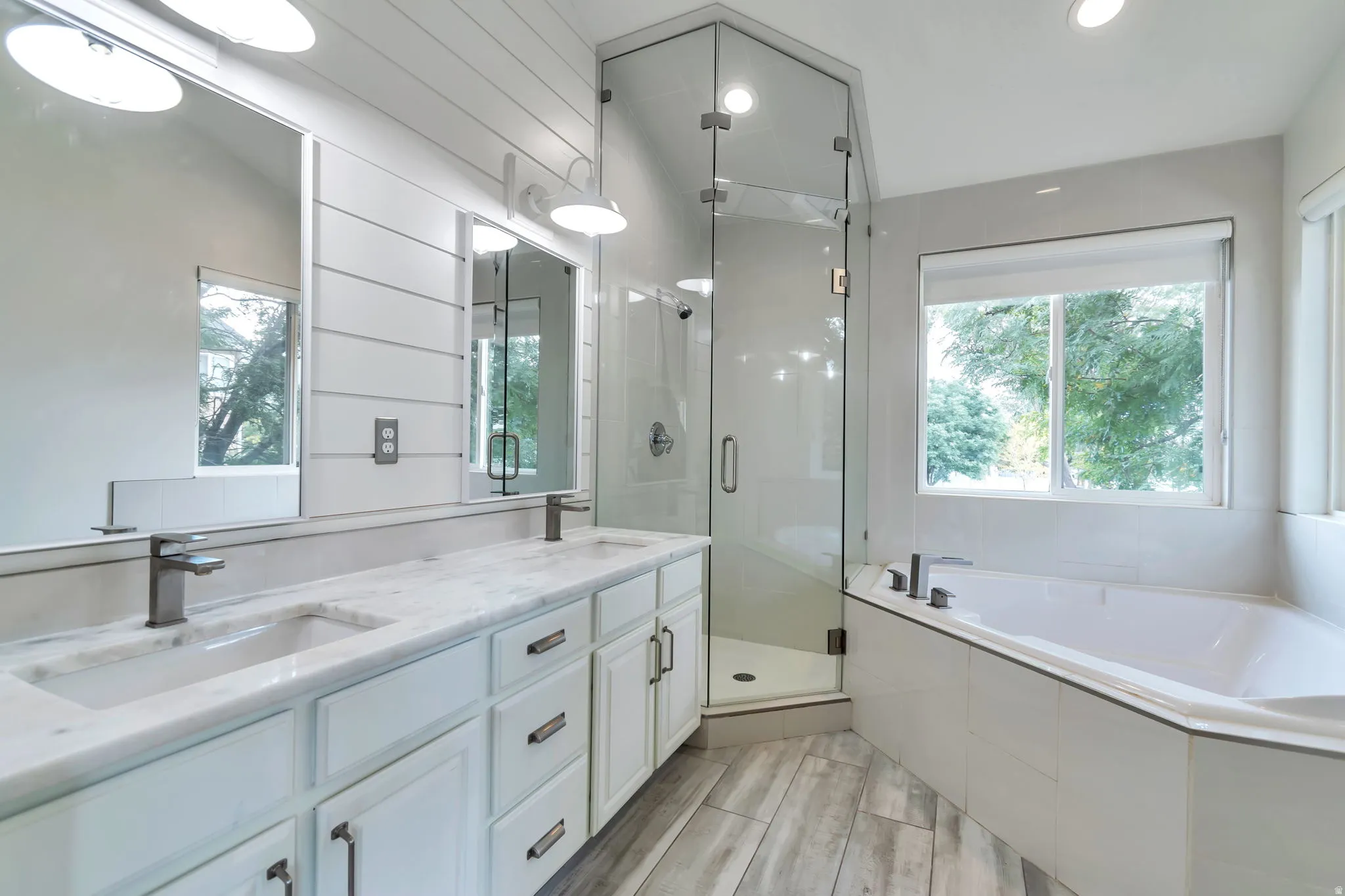 Dual vanity with undermount sinks, stone countertop, and contemporary faucets
