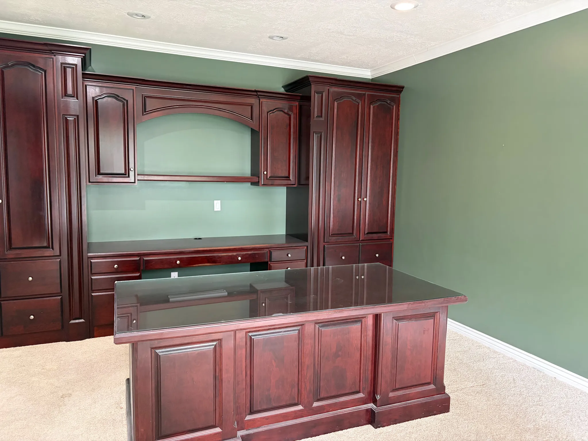 Built-in mahogany cabinetry and desk with an integrated desktop surface