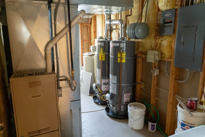 Dual water heaters, furnace system, exposed wood framing, and electrical panels