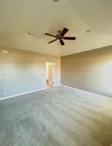 Carpeted room featuring a ceiling fan, recessed lighting, and a neutral wall palette