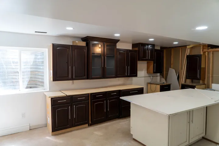 Basement kitchen is 1/2 finished. Dark wood-finish cabinetry with glass-front accents