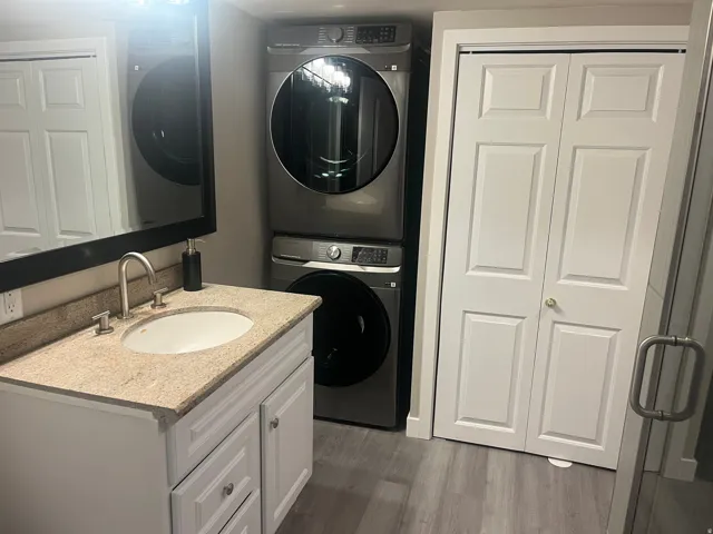 Vanity with a light-colored countertop, undermount sink, and brushed nickel faucet
